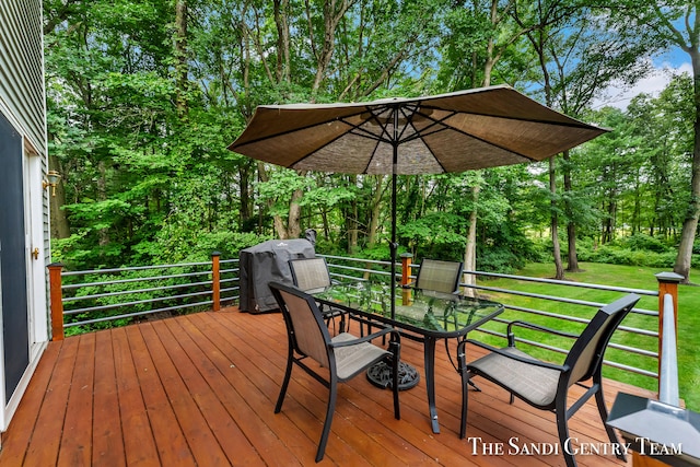 deck featuring grilling area and a yard