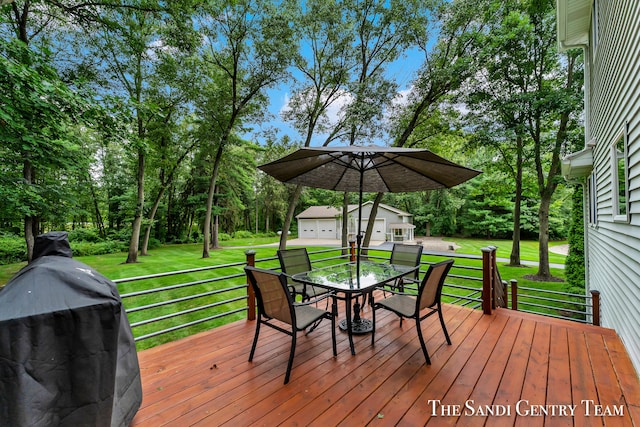 deck with a lawn and area for grilling