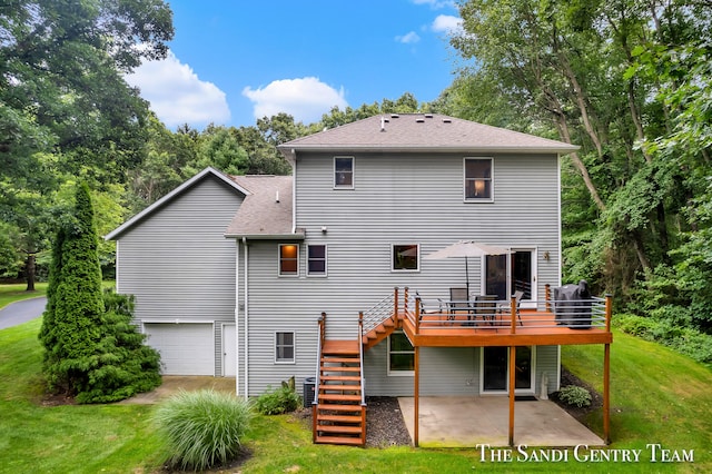 back of property featuring a lawn, a deck, central AC, a garage, and a patio