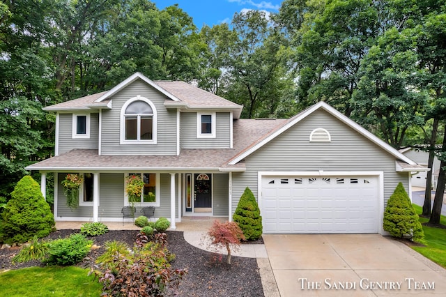 view of front of property with covered porch and a garage