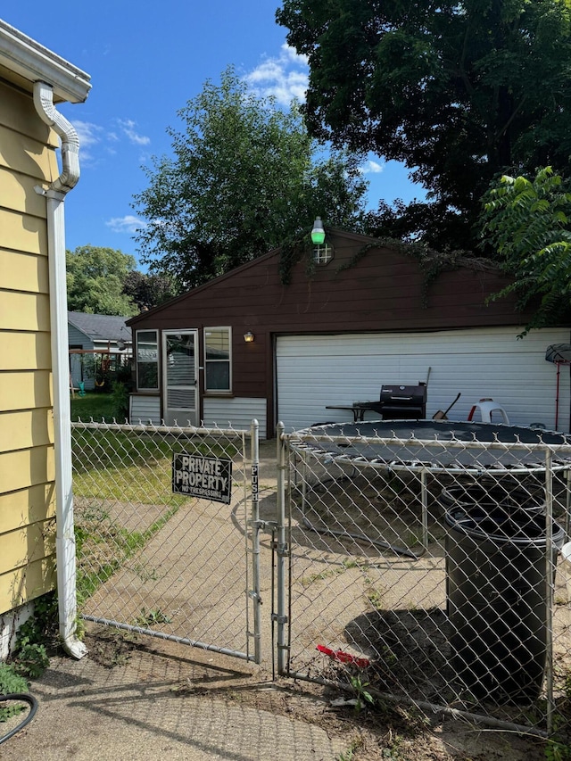 exterior space featuring a garage, an outbuilding, and fence