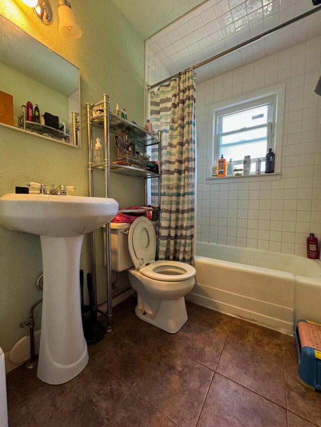 full bathroom featuring sink, toilet, shower / tub combo with curtain, and tile patterned floors