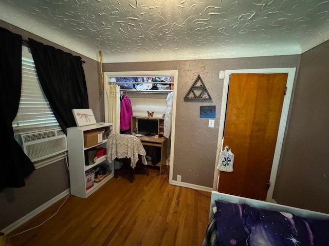 bedroom featuring hardwood / wood-style floors and cooling unit