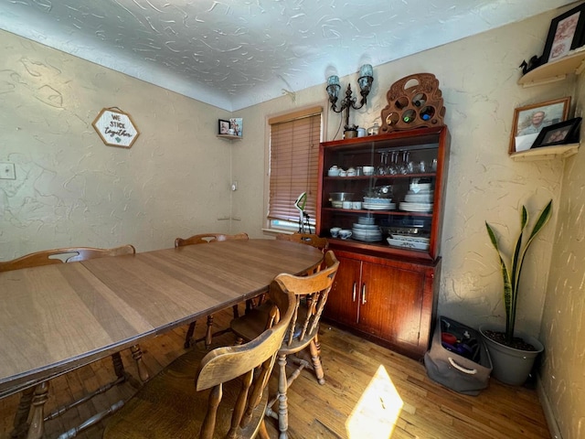 dining space featuring wood-type flooring