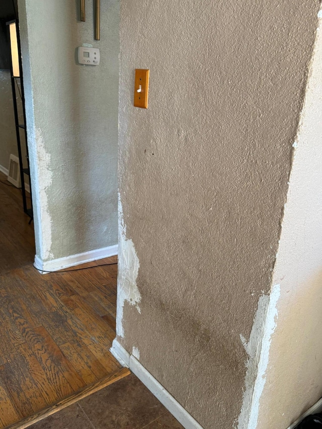 details featuring visible vents, baseboards, and wood finished floors