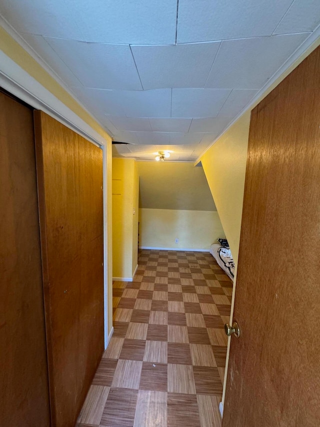 corridor with tile patterned flooring and ornamental molding