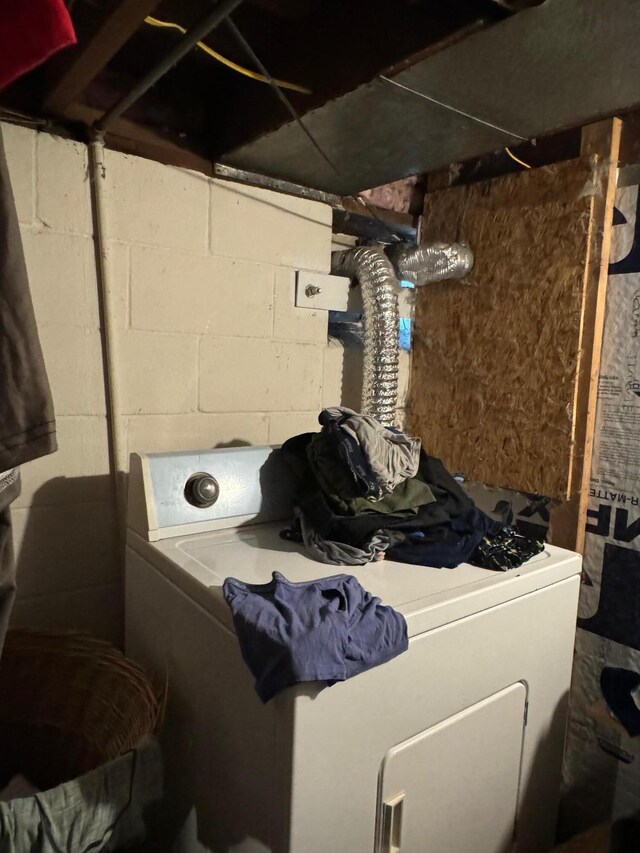 clothes washing area featuring washer / dryer