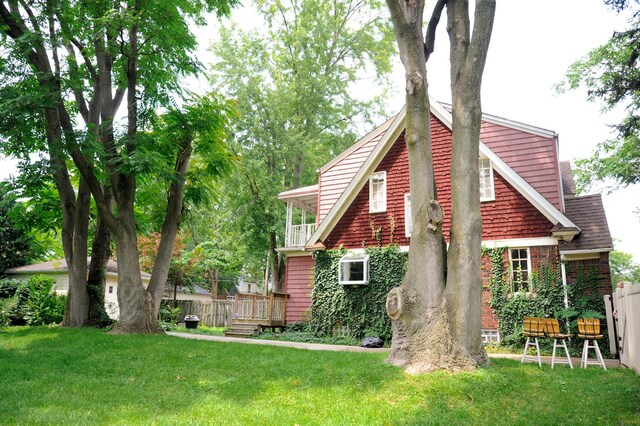 rear view of property featuring a lawn