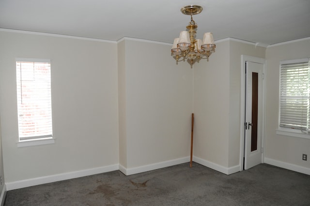 unfurnished room featuring a notable chandelier, dark colored carpet, and plenty of natural light