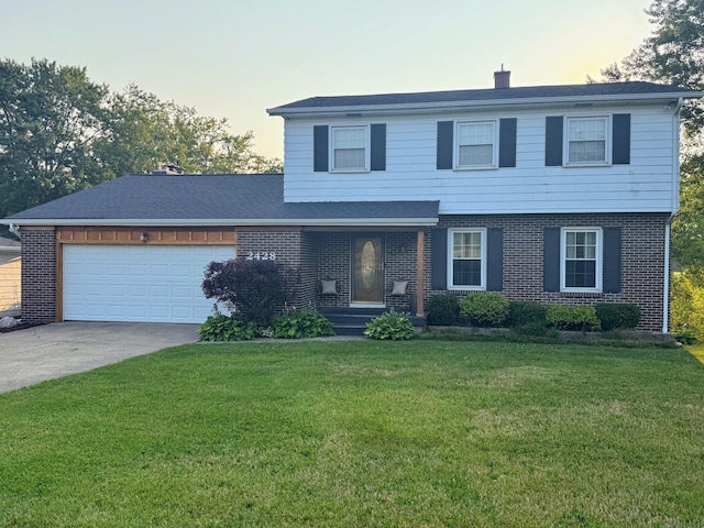 front facade featuring a front lawn and a garage