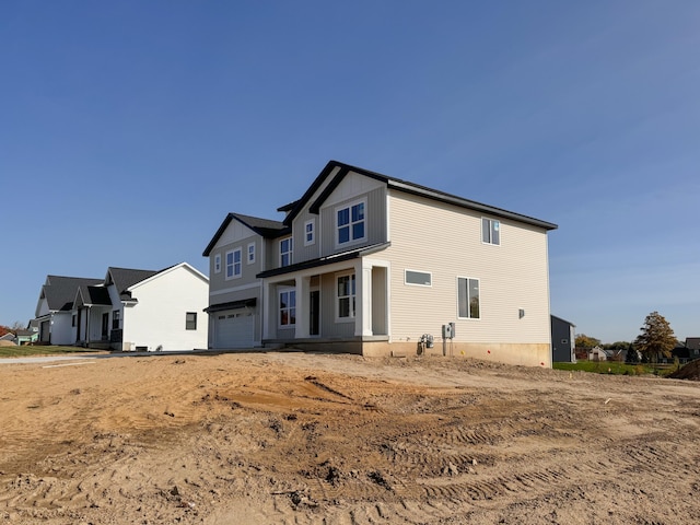 back of property with a garage and board and batten siding