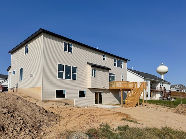 back of property with a patio area, stairway, and a wooden deck