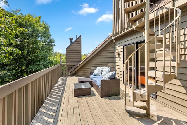 wooden terrace with an outdoor living space