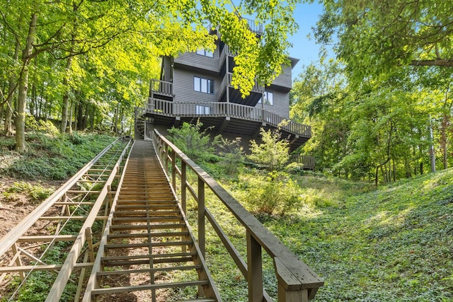 back of house featuring a deck and stairway