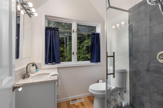 full bathroom featuring visible vents, toilet, wood finished floors, lofted ceiling, and vanity