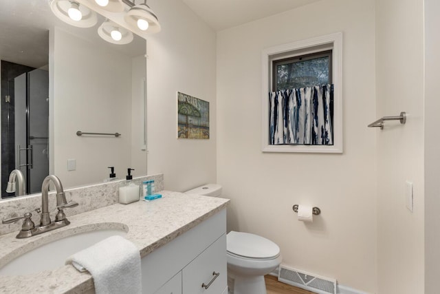 full bath featuring visible vents, toilet, a stall shower, wood finished floors, and vanity