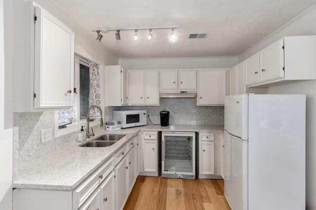 kitchen featuring white appliances, visible vents, a sink, wine cooler, and white cabinets