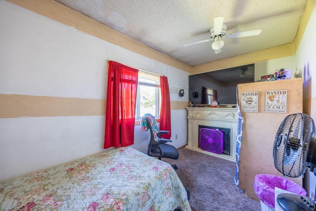 carpeted bedroom with a fireplace, a ceiling fan, and a textured ceiling