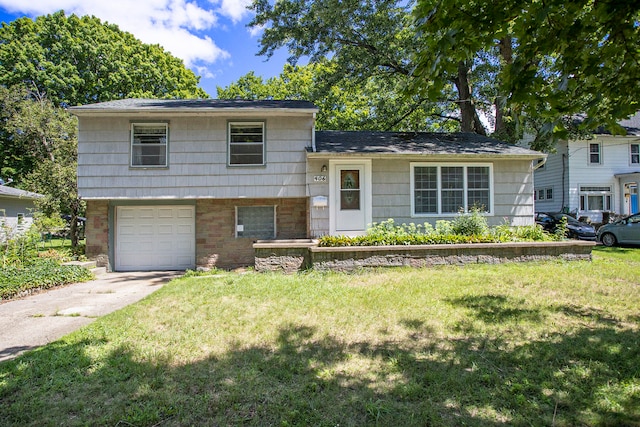 split level home with a front yard and a garage