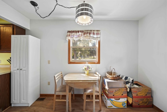 dining area with hardwood / wood-style floors