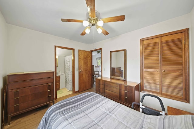 bedroom with ensuite bath, light hardwood / wood-style flooring, a closet, and ceiling fan