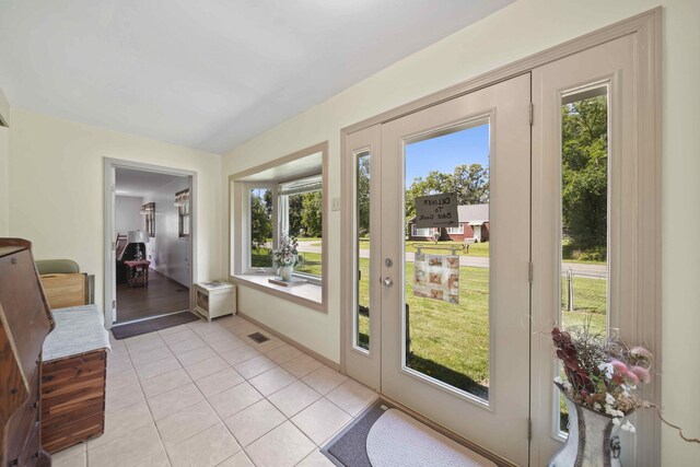 doorway to outside with light tile patterned flooring