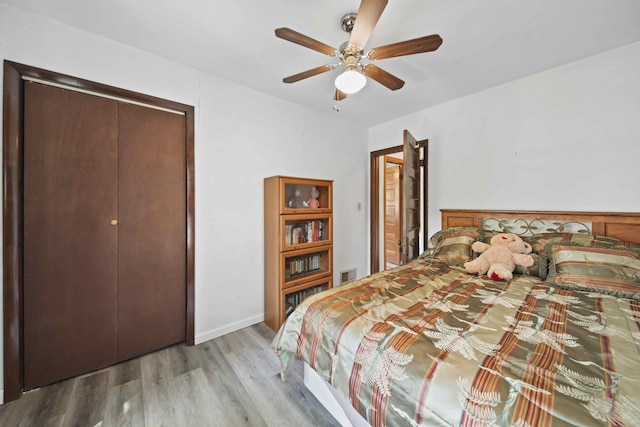 bedroom with ceiling fan, light wood-type flooring, and a closet