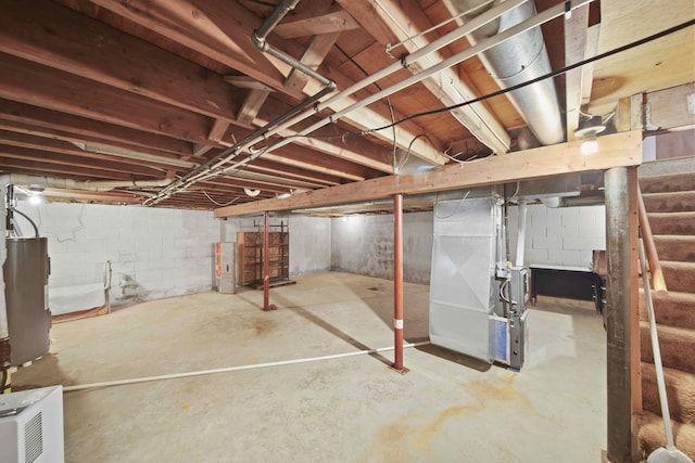 basement featuring water heater and heating unit