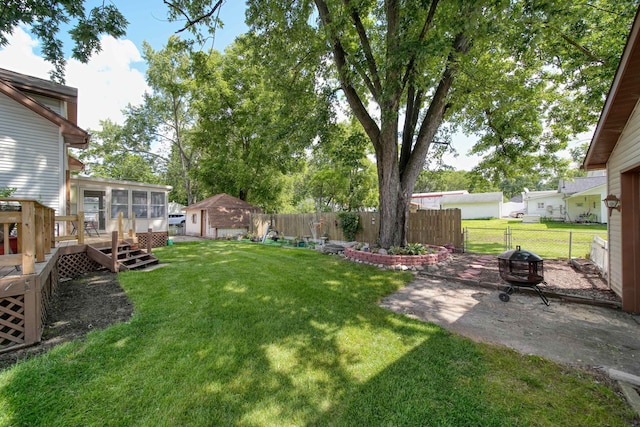 view of yard with a patio area, a deck, and a fire pit