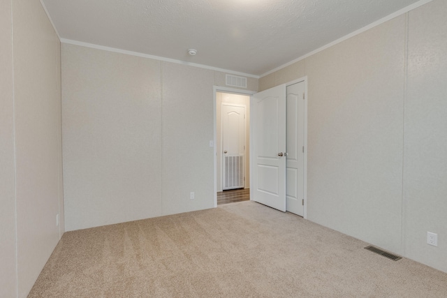 carpeted empty room with ornamental molding