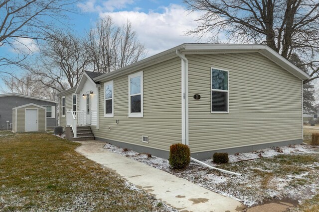 view of side of home featuring an outbuilding