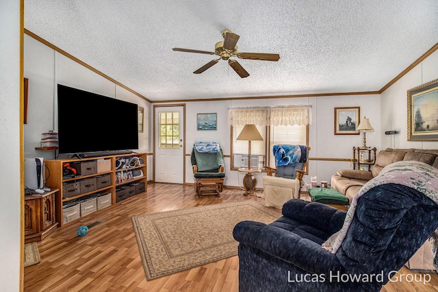 living room with ceiling fan, light hardwood / wood-style flooring, ornamental molding, cooling unit, and a textured ceiling