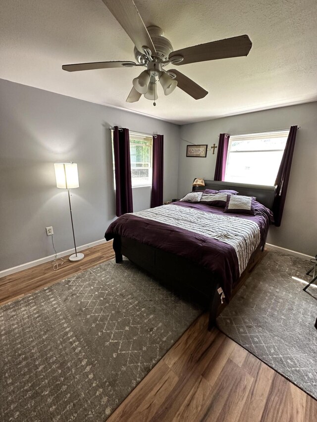 bedroom with ceiling fan and hardwood / wood-style flooring