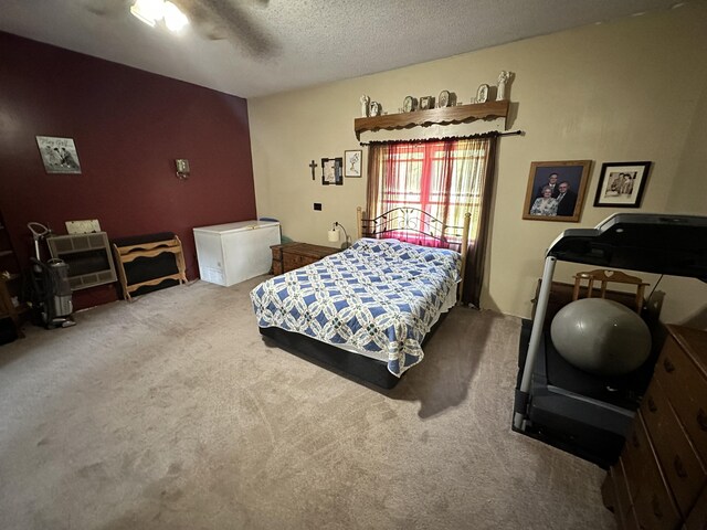 carpeted bedroom featuring a textured ceiling and ceiling fan