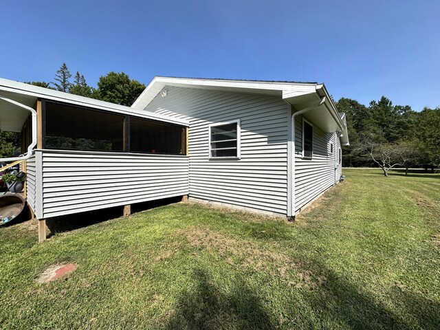 view of side of property with a lawn