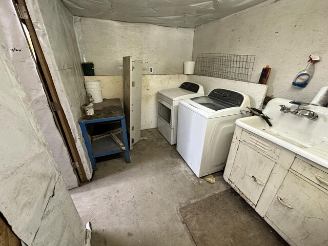 clothes washing area with washer and clothes dryer