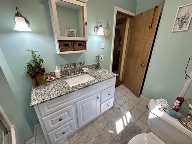 bathroom with vanity, toilet, and tile patterned flooring