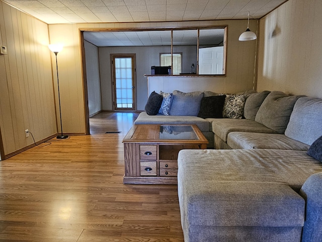 living area featuring wood finished floors and visible vents