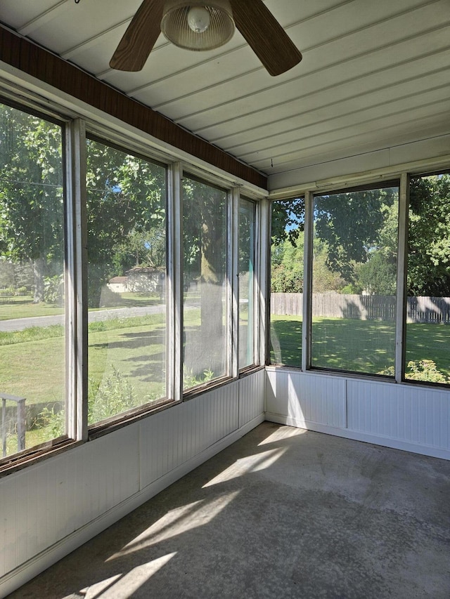 unfurnished sunroom featuring a ceiling fan