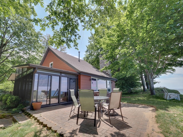 rear view of house with a patio and a sunroom