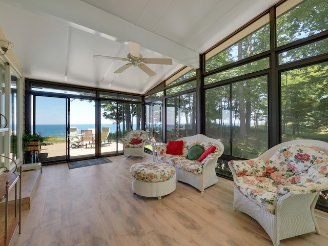 sunroom / solarium featuring a water view, ceiling fan, and vaulted ceiling with beams