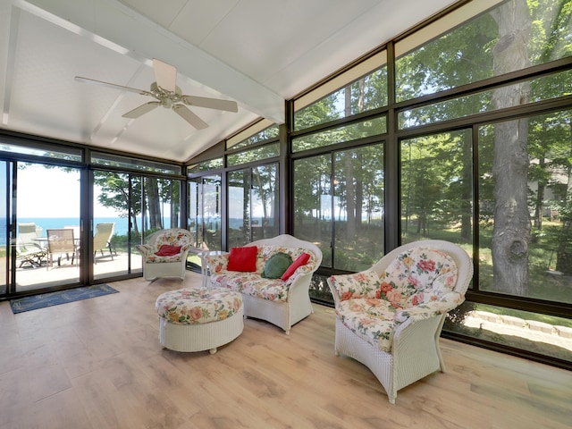 sunroom with a water view, ceiling fan, and lofted ceiling with beams