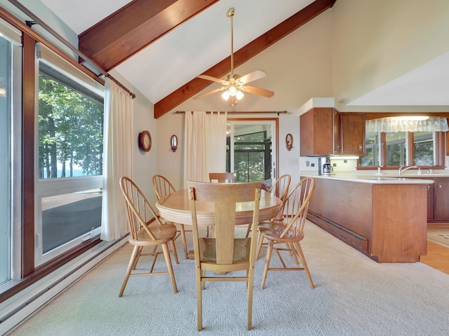 carpeted dining room with beamed ceiling, a wealth of natural light, high vaulted ceiling, and ceiling fan