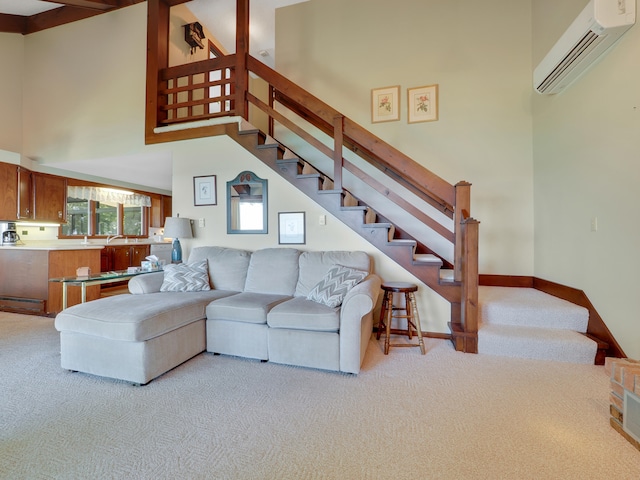 carpeted living room featuring an AC wall unit and a high ceiling