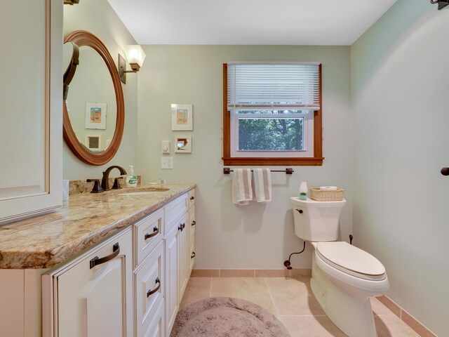 bathroom with vanity, toilet, and tile patterned flooring