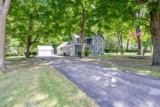 view of front of property with a garage and an outbuilding