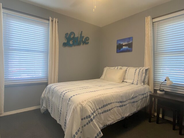 bedroom featuring dark colored carpet