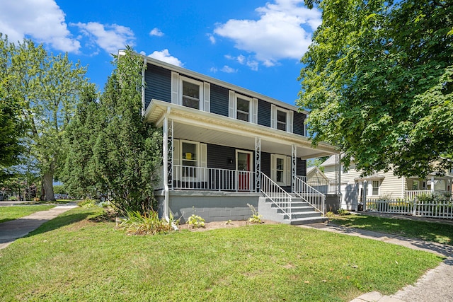 view of front of home with a front yard and covered porch