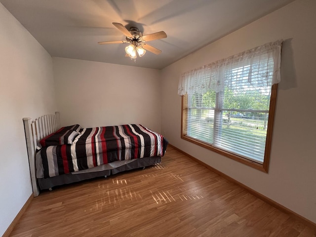 bedroom featuring hardwood / wood-style flooring and ceiling fan