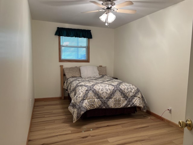 bedroom with ceiling fan and light hardwood / wood-style flooring